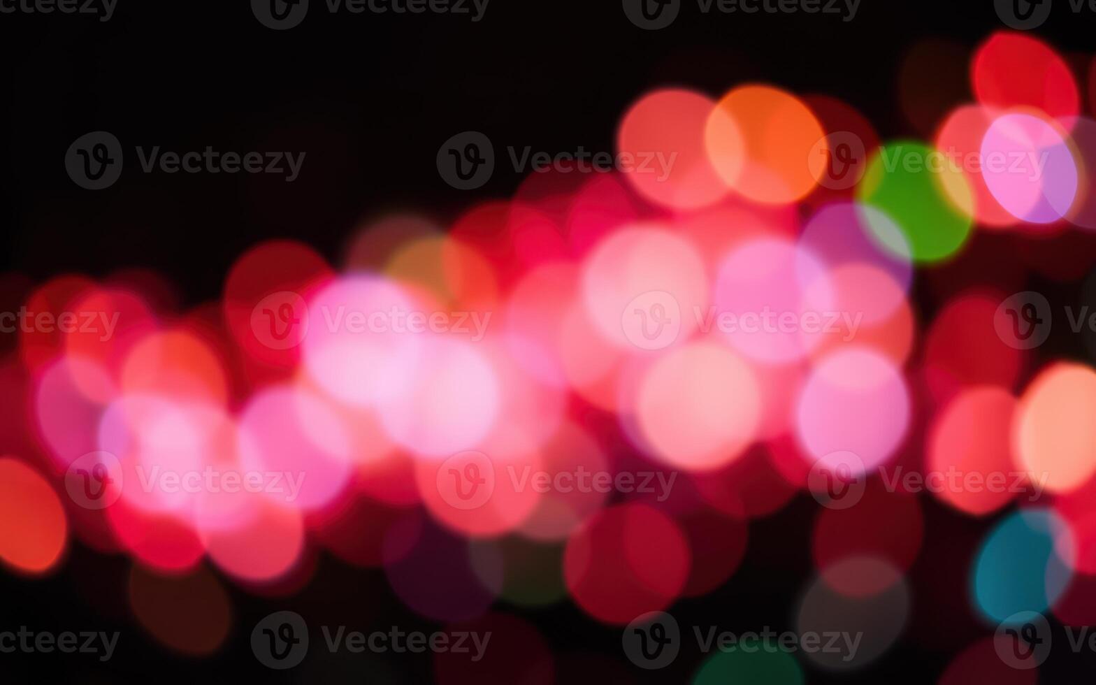 Colorful light patterns create a vibrant atmosphere during a night event in an urban setting, adding energy and excitement to the surroundings photo