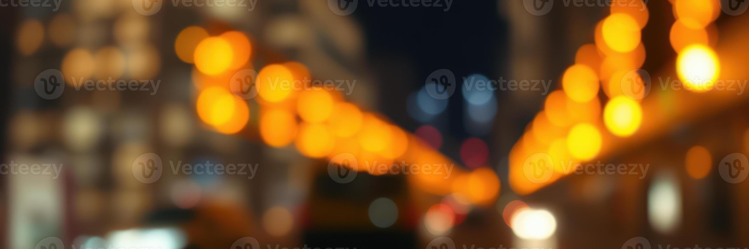 City street illuminated by glowing lights during evening hours creates a vibrant atmosphere for passersby photo