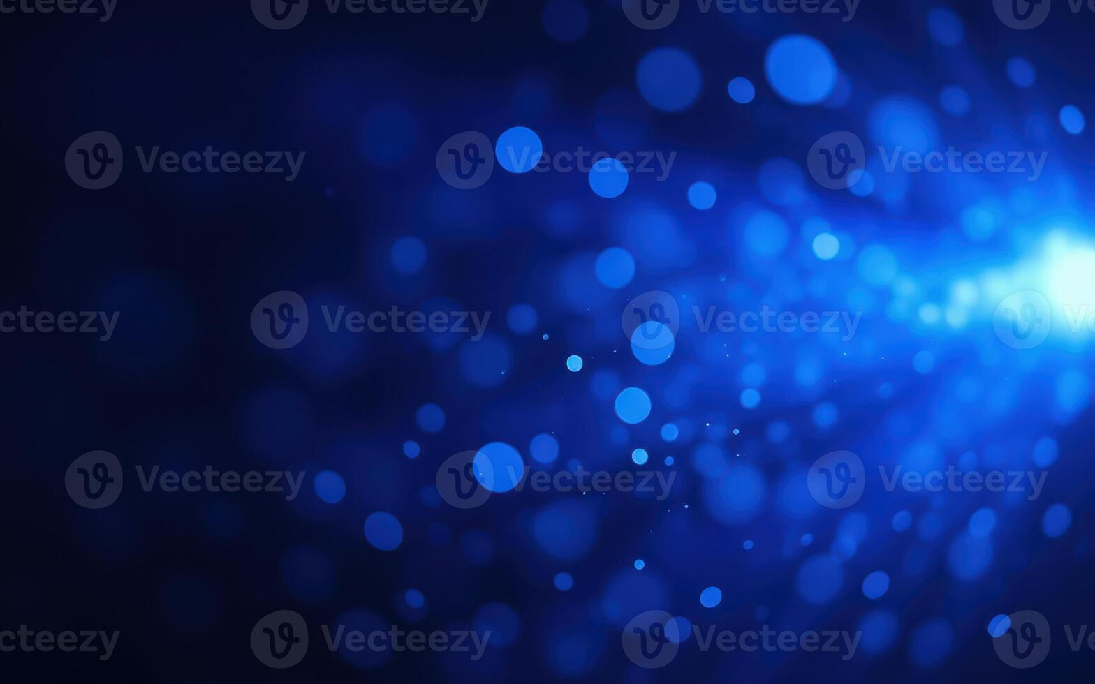 Blue abstract background with glowing particles creating a dynamic visual effect in a dark space photo