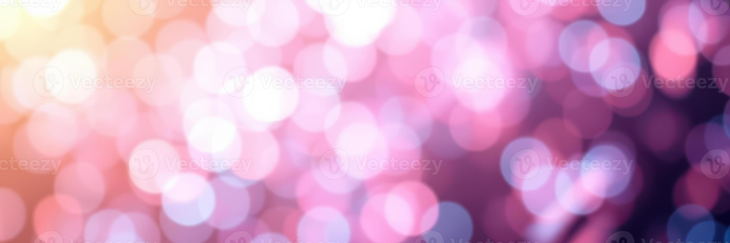 Beautiful bokeh lights create a dreamy atmosphere in soft pink and purple hues during a festive evening celebration photo