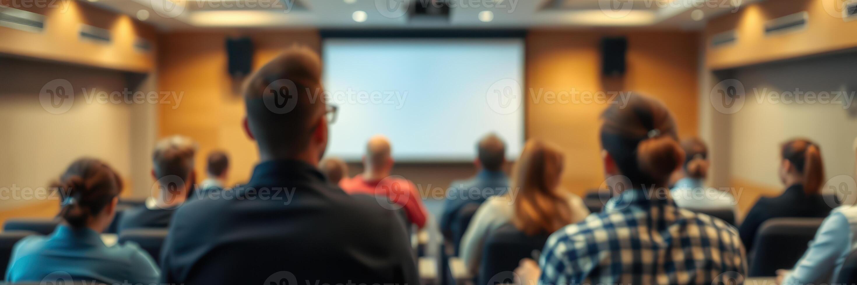 Audience attending a conference presentation in a modern seminar room focused on professional development topics photo