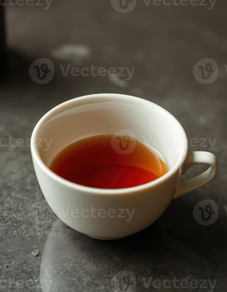 Warm cup of tea on a marble table reflecting cozy indoor ambiance during a quiet afternoon photo