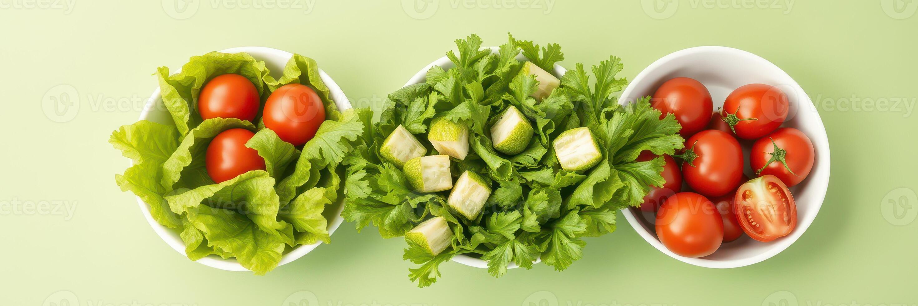 Fresh salad ingredients arranged in bowls on a light green background for healthy meal preparation photo