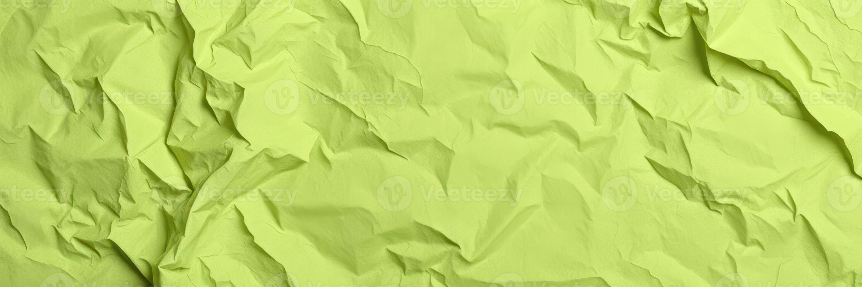Textured crumpled green paper background for creative design and crafts photo