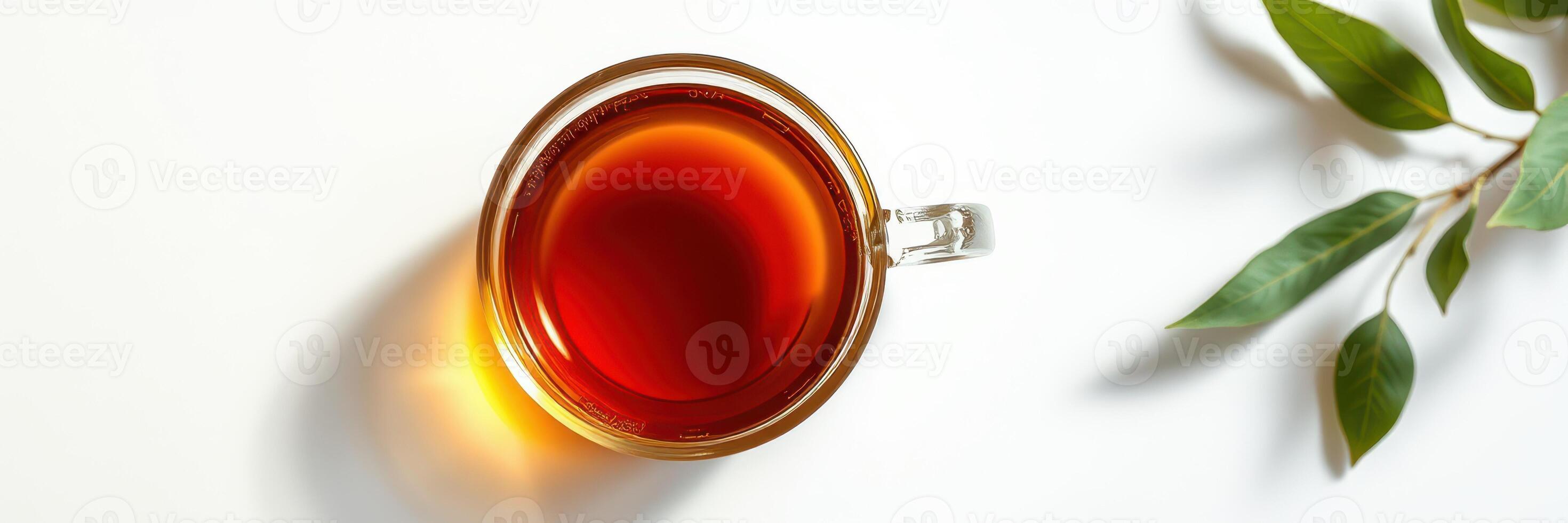 Warm cup of herbal tea on a light surface with green leaves enhancing a calm atmosphere photo