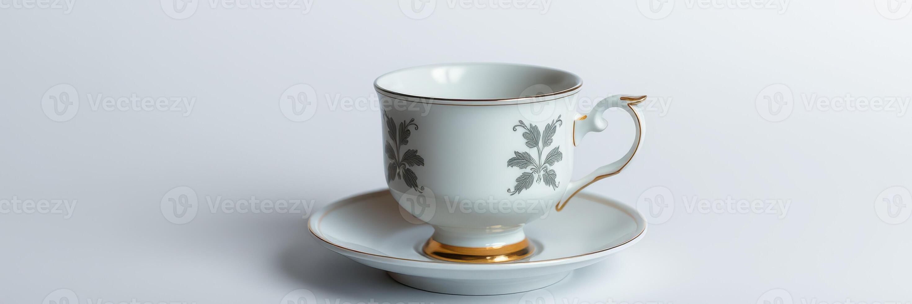 Elegant porcelain tea cup on saucer with intricate design placed on a light background photo