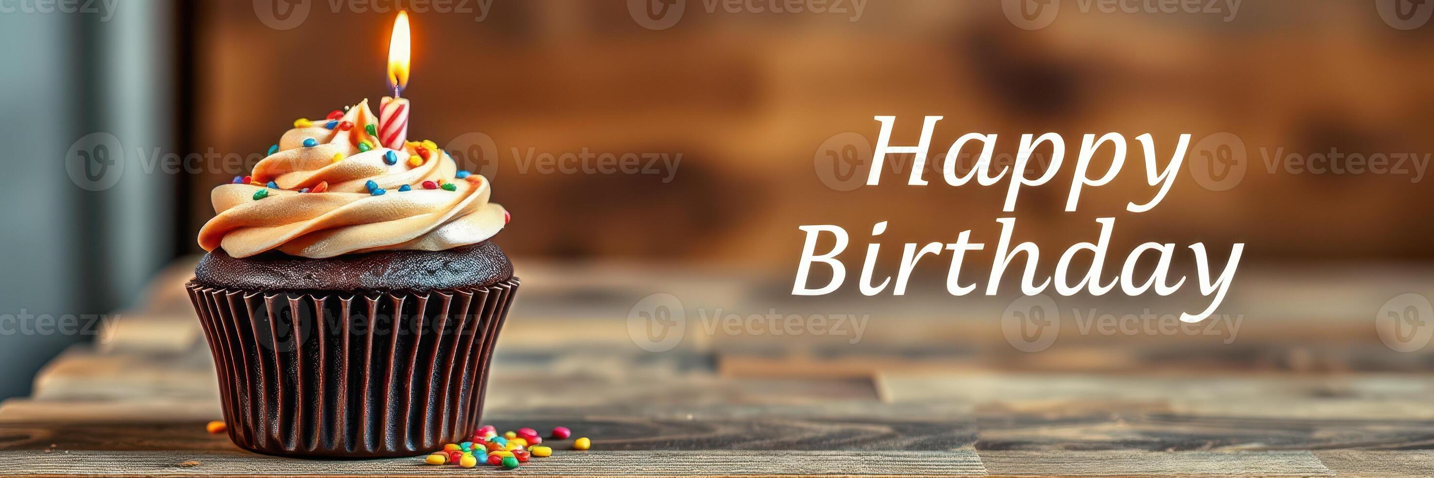 Celebrate a special birthday with a beautifully decorated cupcake featuring a lit candle and colorful sprinkles photo