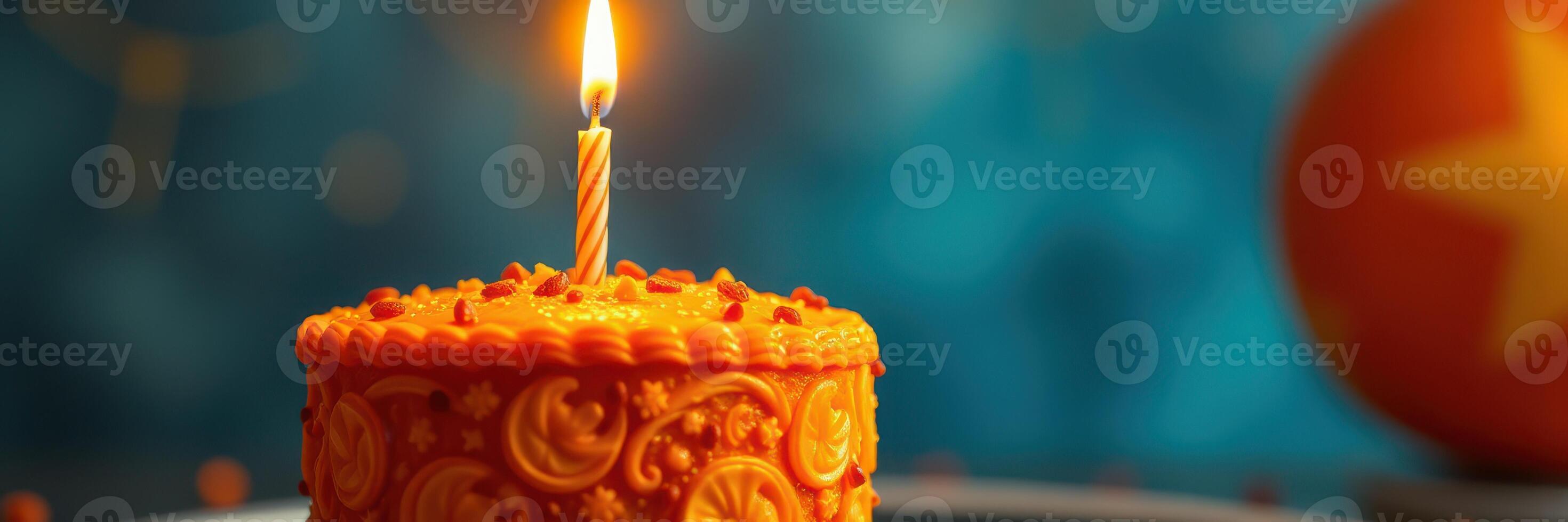 Colorful orange birthday cake with a single candle glowing brightly in a festive setting photo