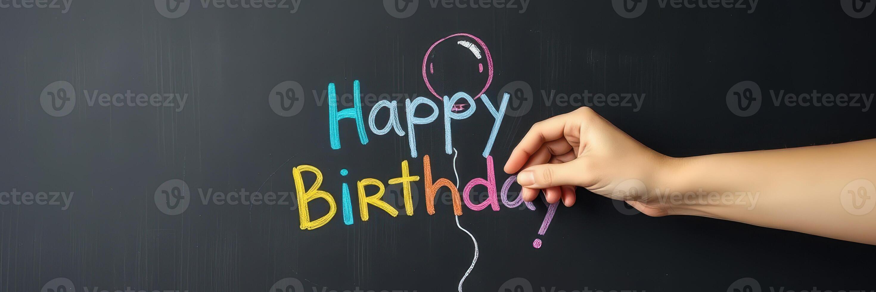 Creating a colorful birthday greeting with chalk on a blackboard during a festive celebration photo