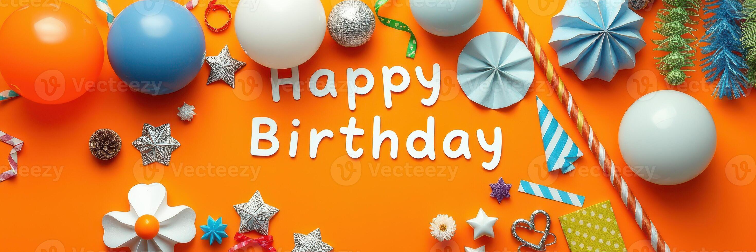 Colorful birthday decorations on an orange background with balloons and crafts displayed for a festive celebration photo