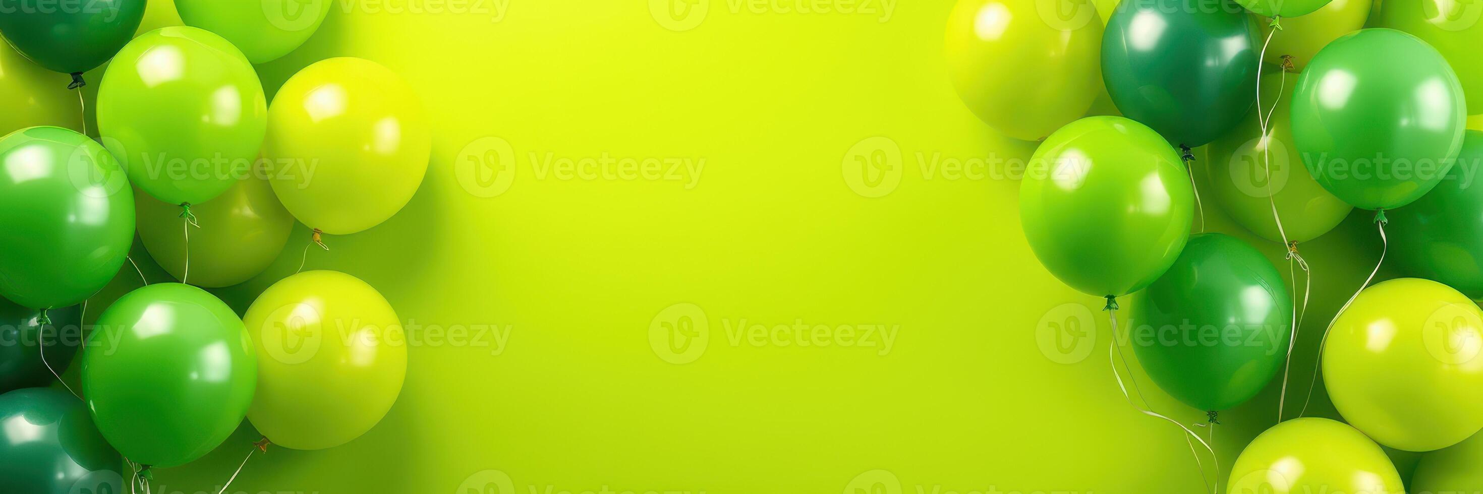 Colorful green and yellow balloons arranged against a bright green background for a festive celebration photo