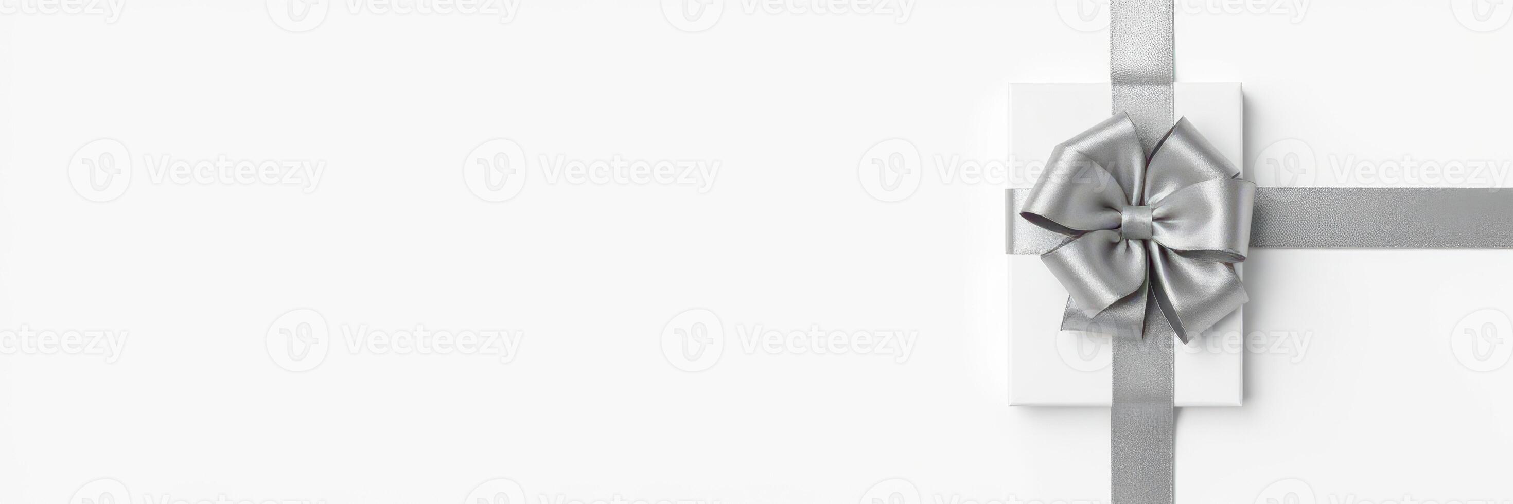 Stylishly wrapped gift box with silver ribbon displayed on a clean white background, perfect for any special occasion photo