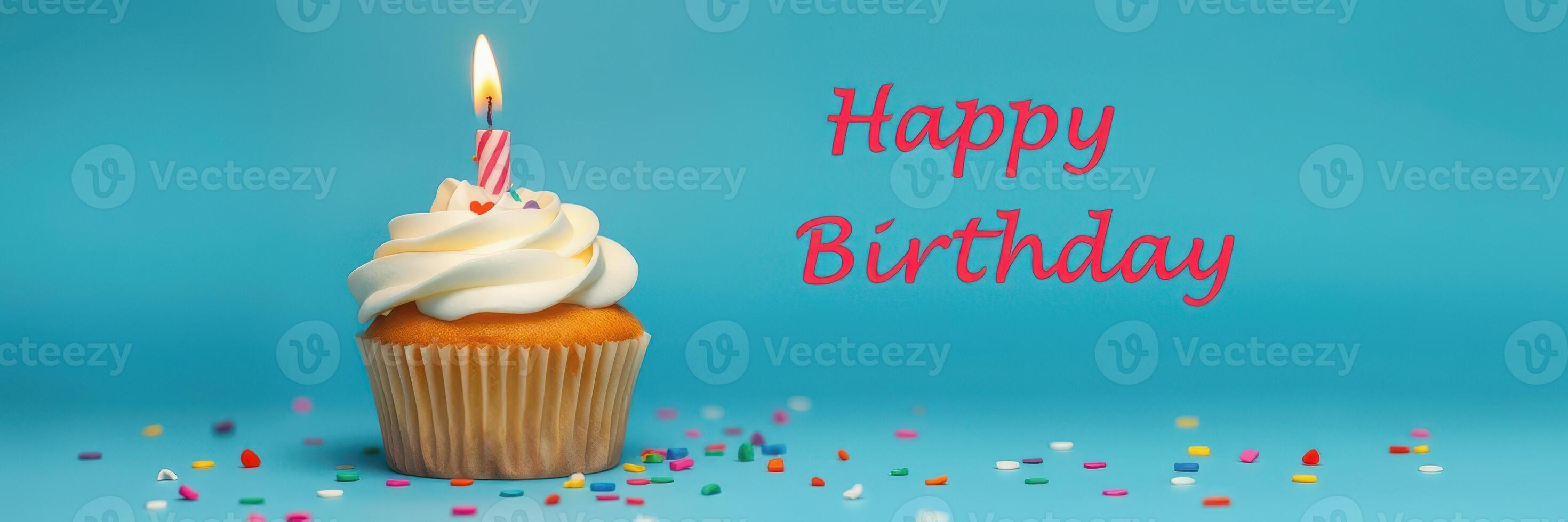 Birthday cupcake with candle and colorful sprinkles on a blue background celebrating a festive occasion photo