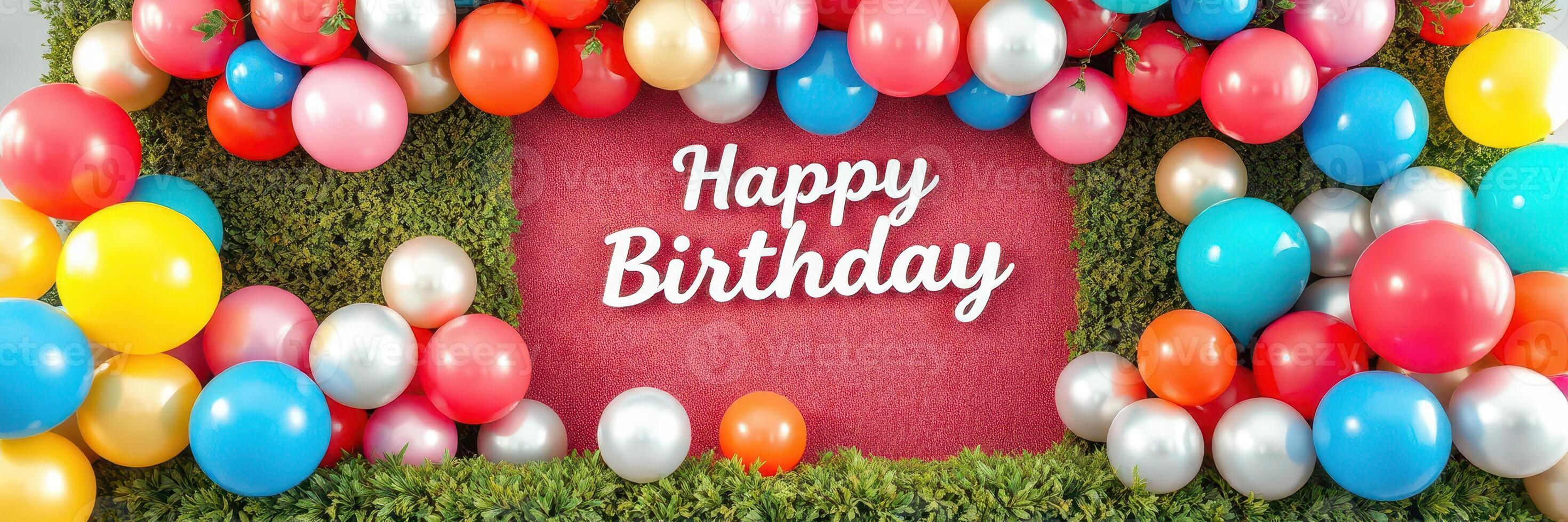 Celebration with colorful balloons and a birthday message on a lush green wall during a festive gathering photo