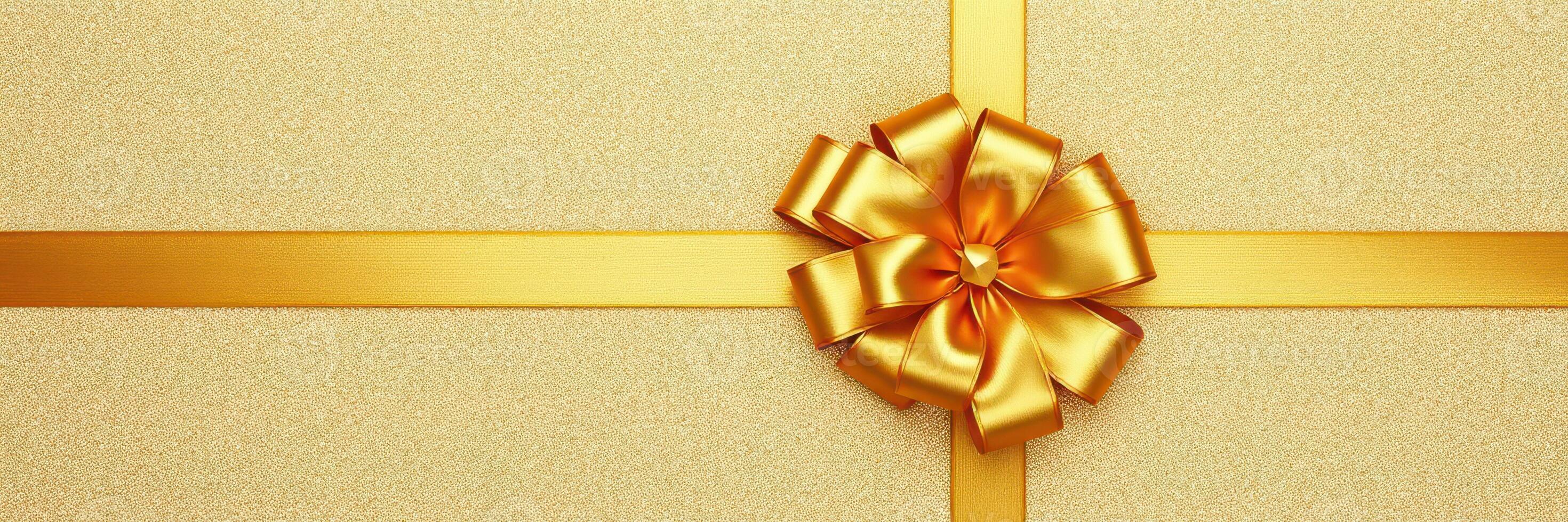 Gift box with golden ribbon and bow on a textured golden background showcasing elegance and celebration photo