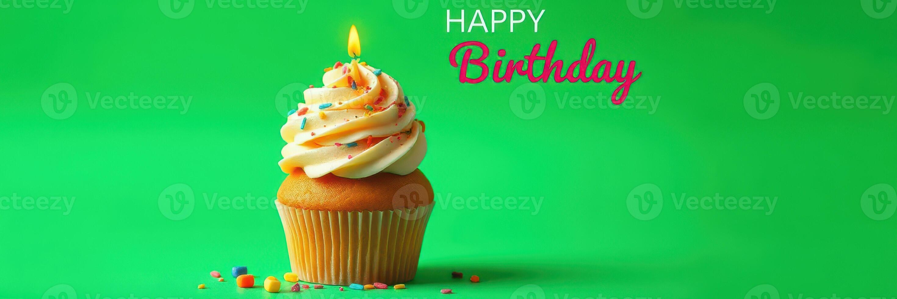 Festive birthday cupcake with frosting and candle against bright green background photo