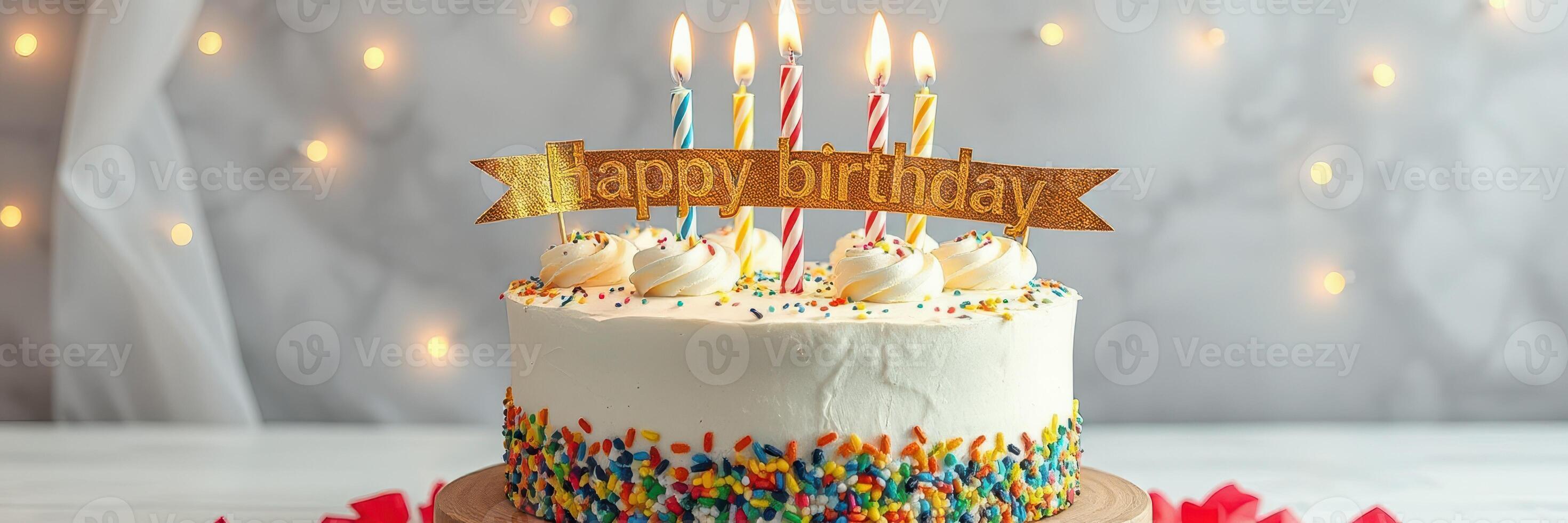 Celebrate with a colorful birthday cake featuring candles and a festive banner at a joyful gathering photo