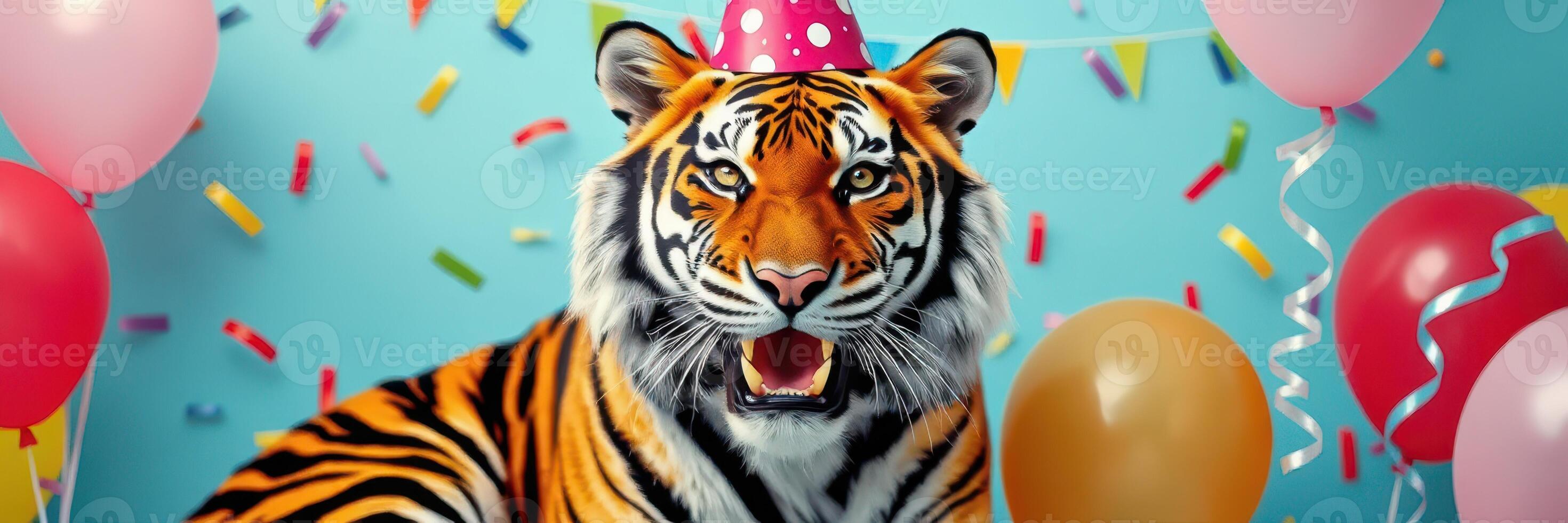 Tiger wearing a party hat celebrates with colorful balloons and confetti photo