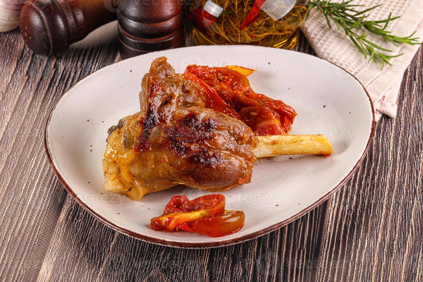 Baked lamb shank with vegetables photo