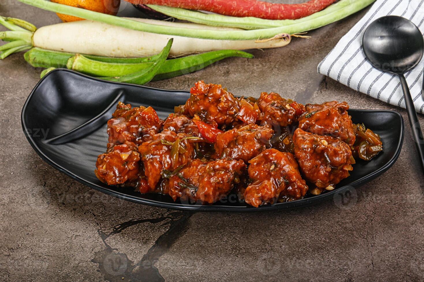 Manchurian chicken with sauce and spices photo
