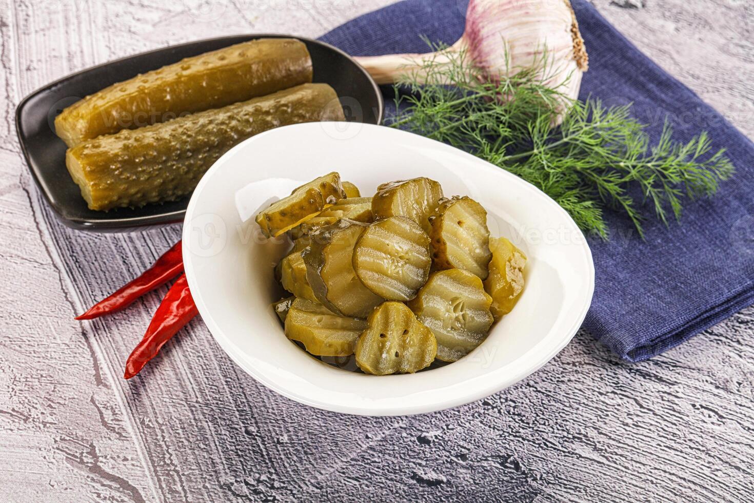 Sliced marinated cucumbers in the bowl photo
