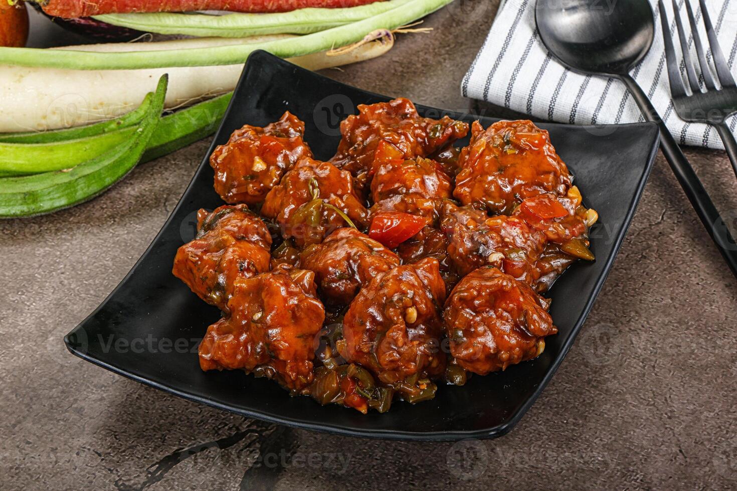 Manchurian chicken with sauce and spices photo
