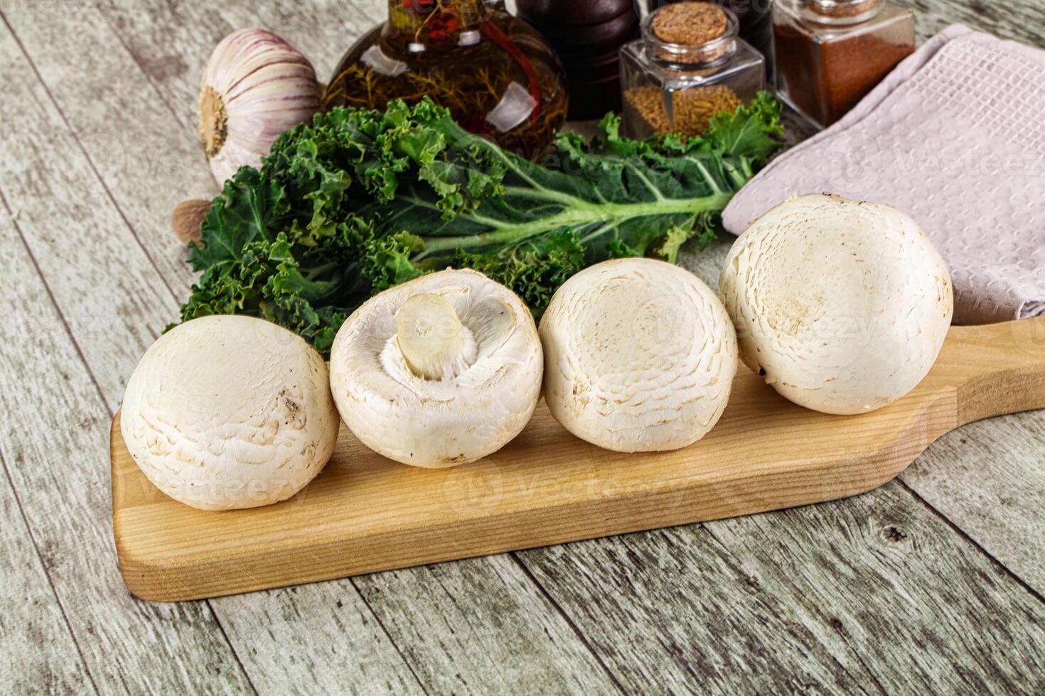White champignon mushrooms heap over board photo