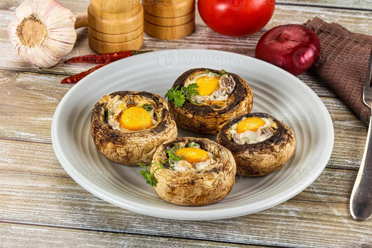 Baked champignon with quail egg photo