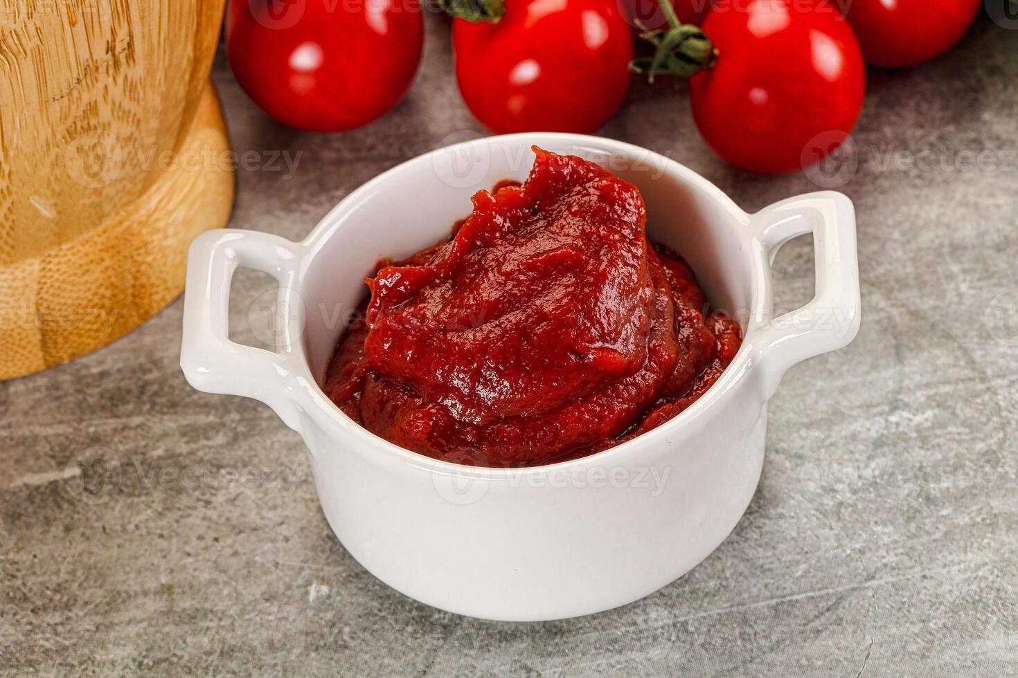 Red tomato paste in the bowl photo