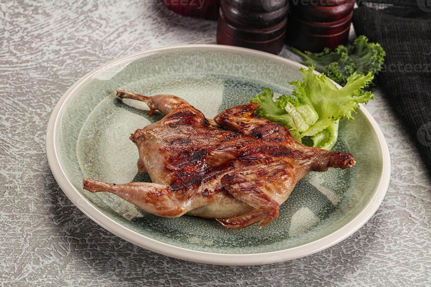 Grilled quail in the plate photo