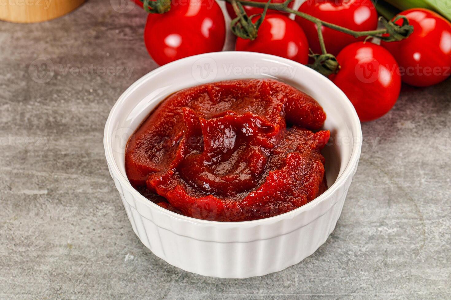Red tomato paste in the bowl photo