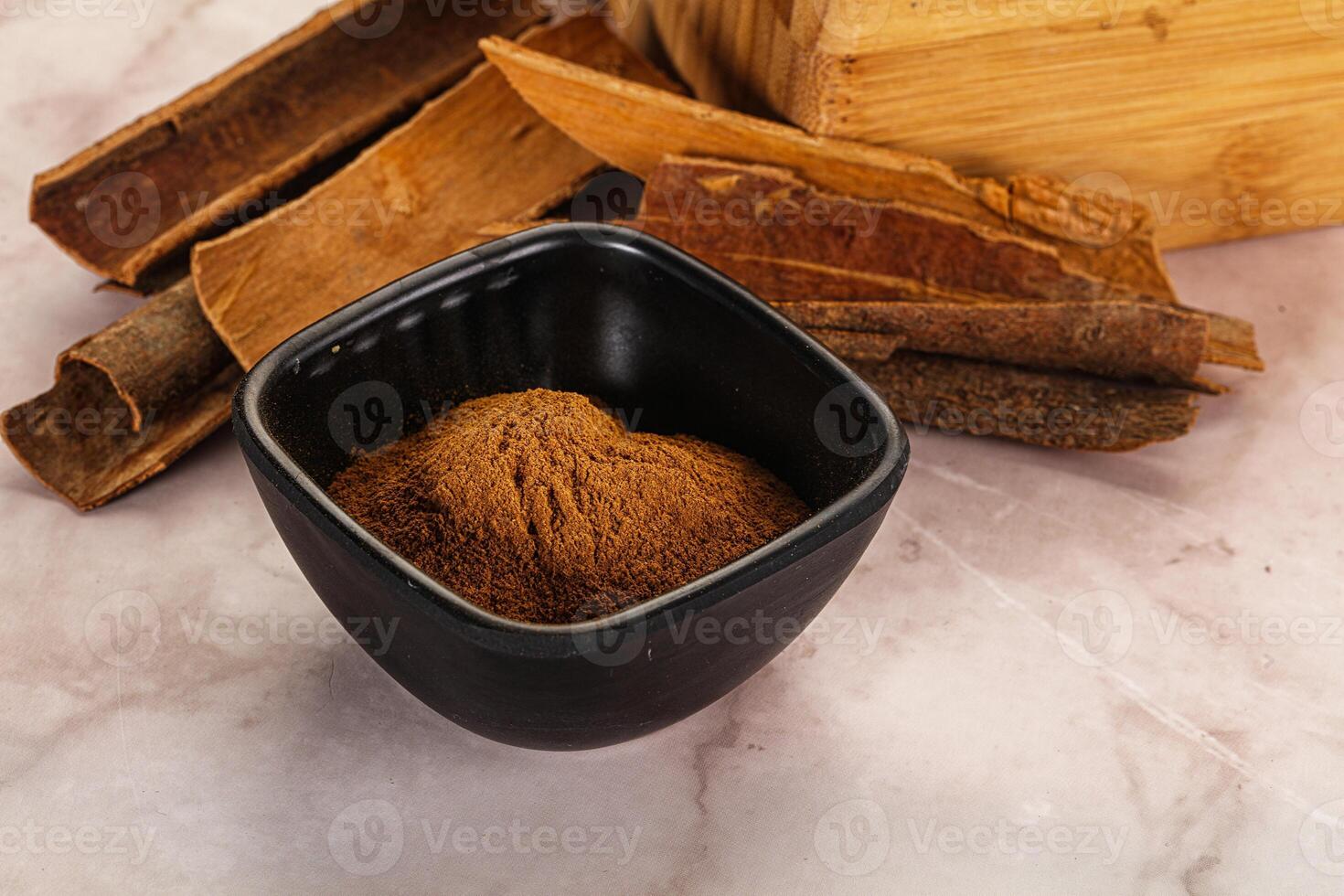 Natural Cinnamon powder with sticks photo