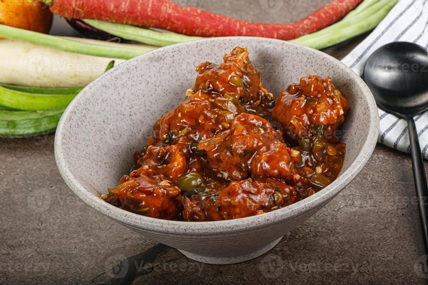 Manchurian chicken with sauce and spices photo