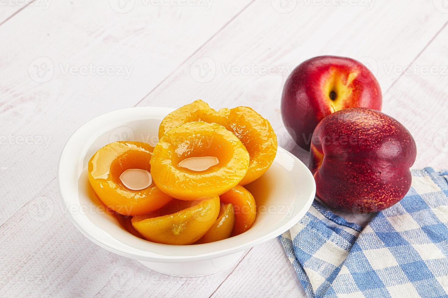 Canned peaches with sweet syrope photo