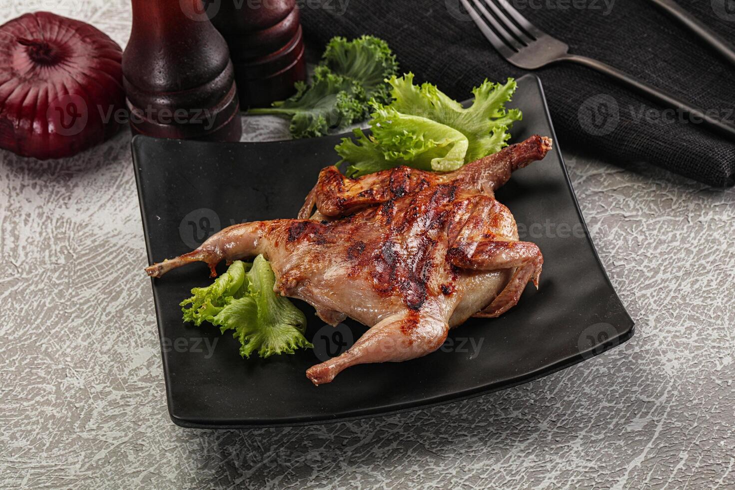 Grilled quail in the plate photo