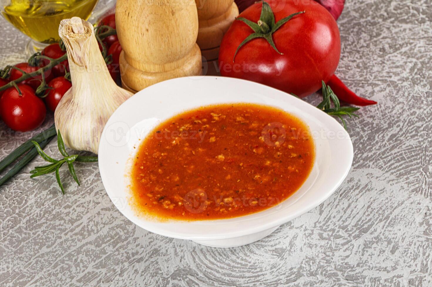 Hot tomato soup with diced chicken photo