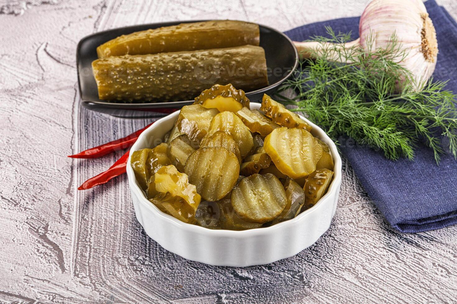 Sliced marinated cucumbers in the bowl photo
