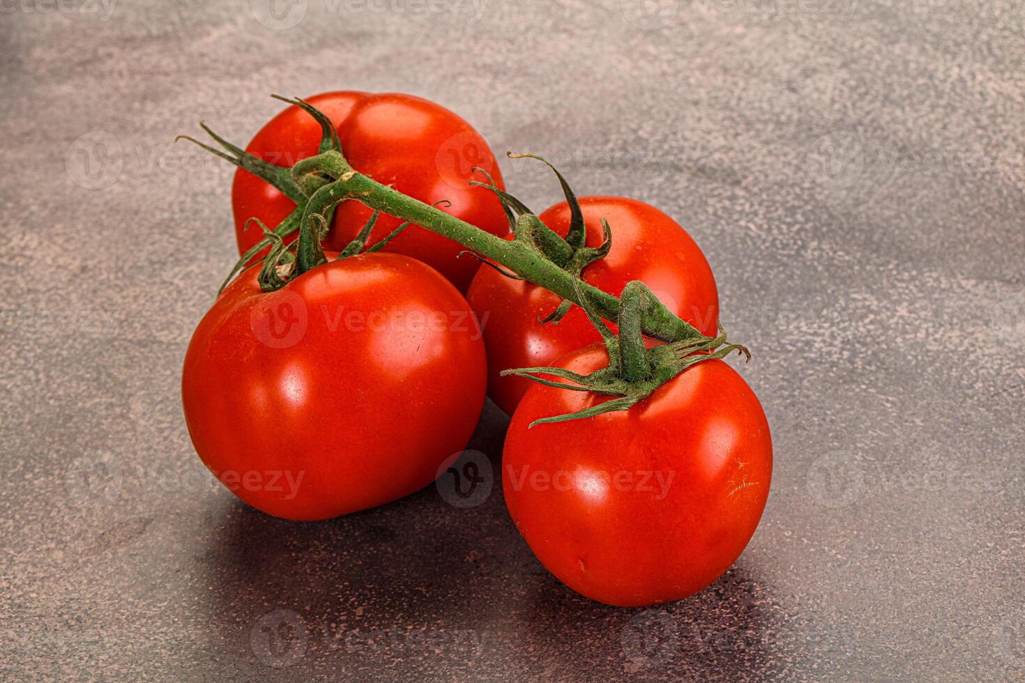 Ripe fresh tomato on the branch photo