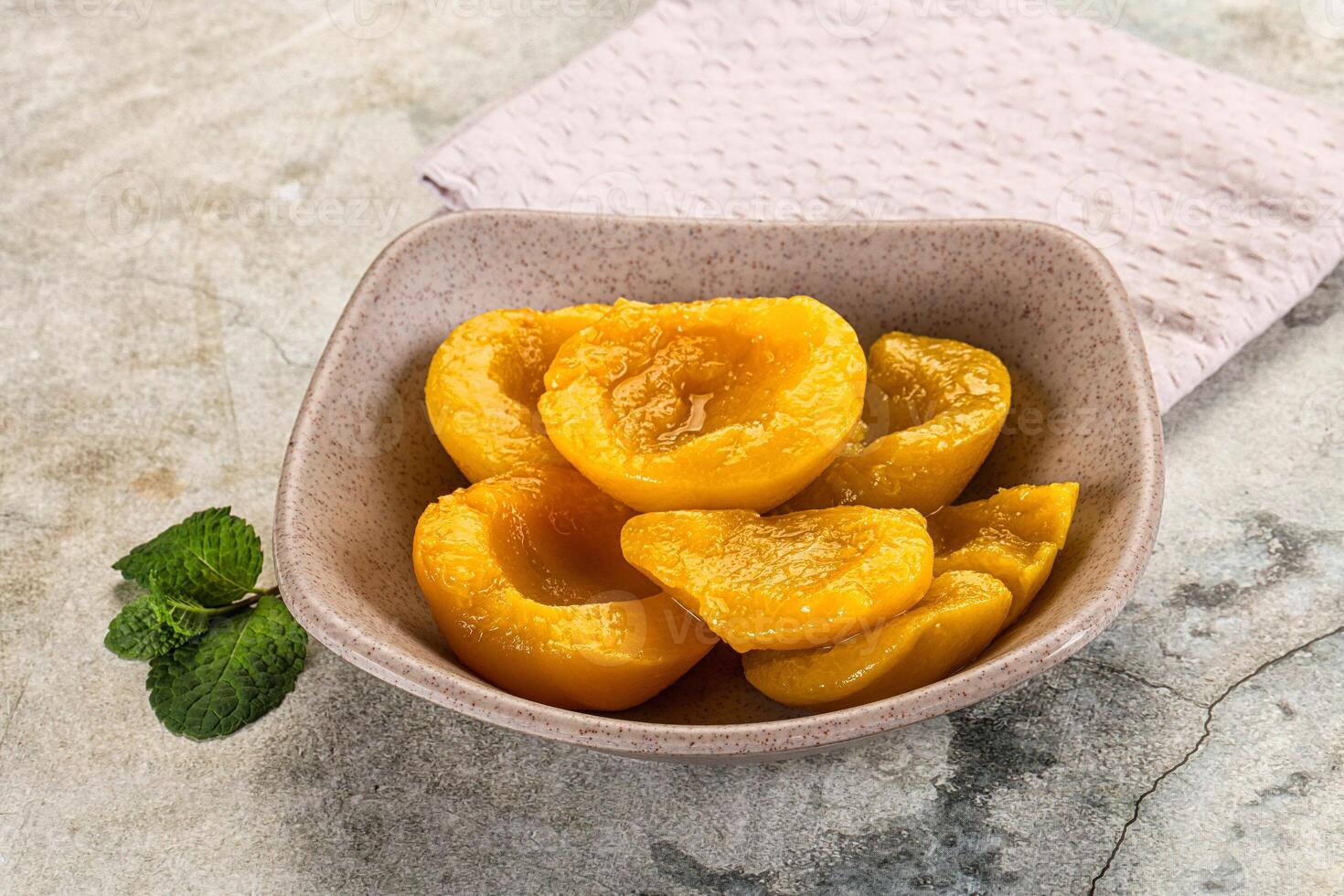 Canned marinated peach in syrop photo