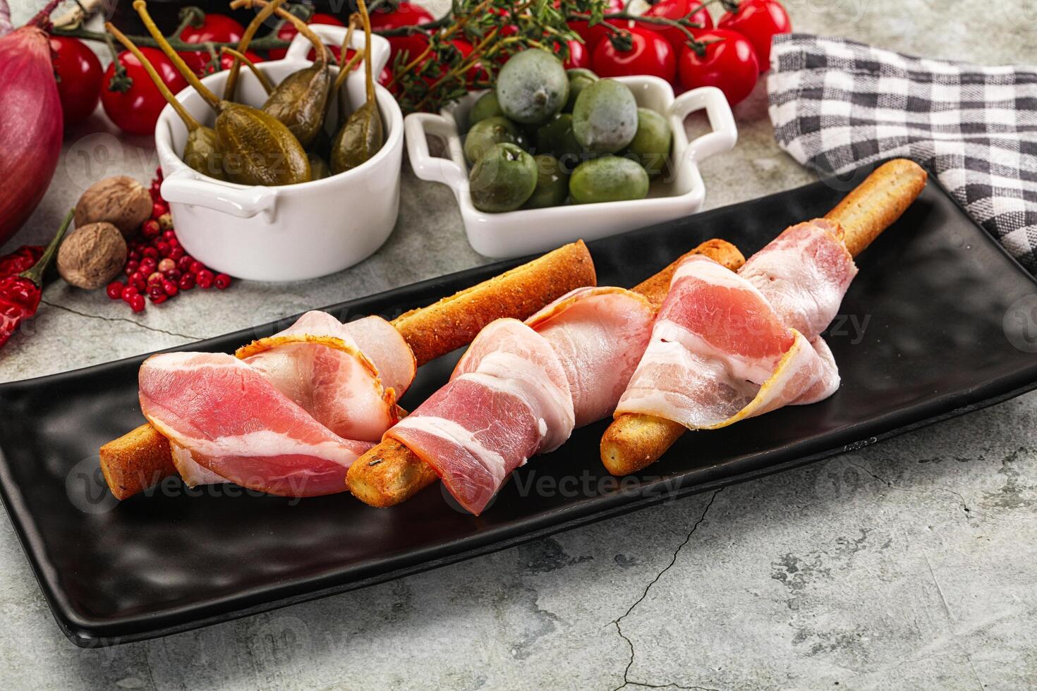 Antipasti - Grissini with pork bacon photo
