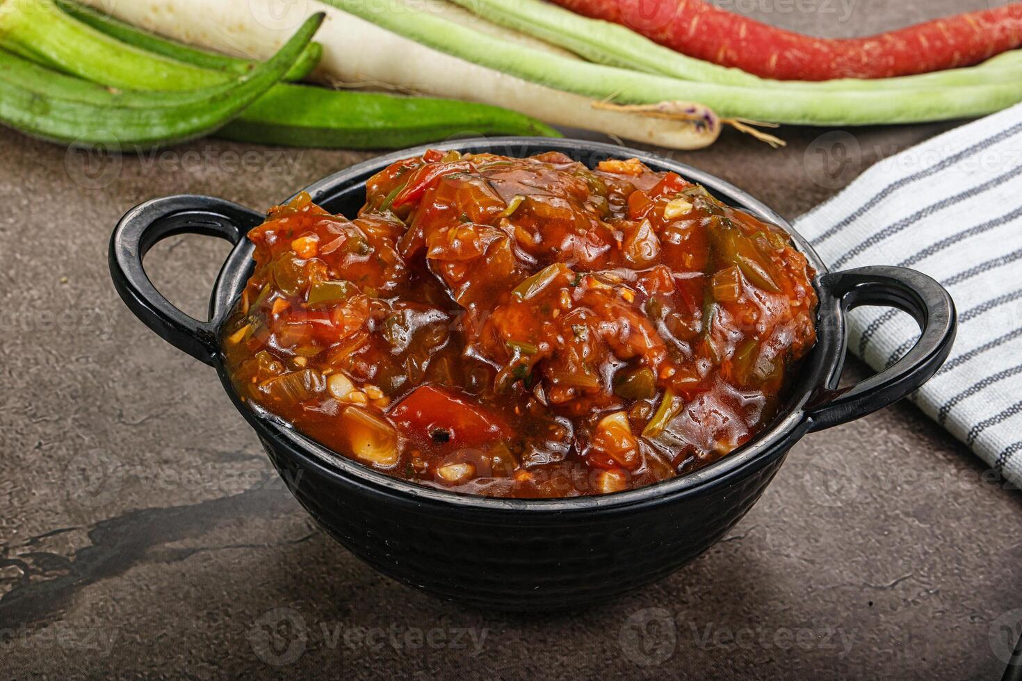 Manchurian chicken with sauce and spices photo