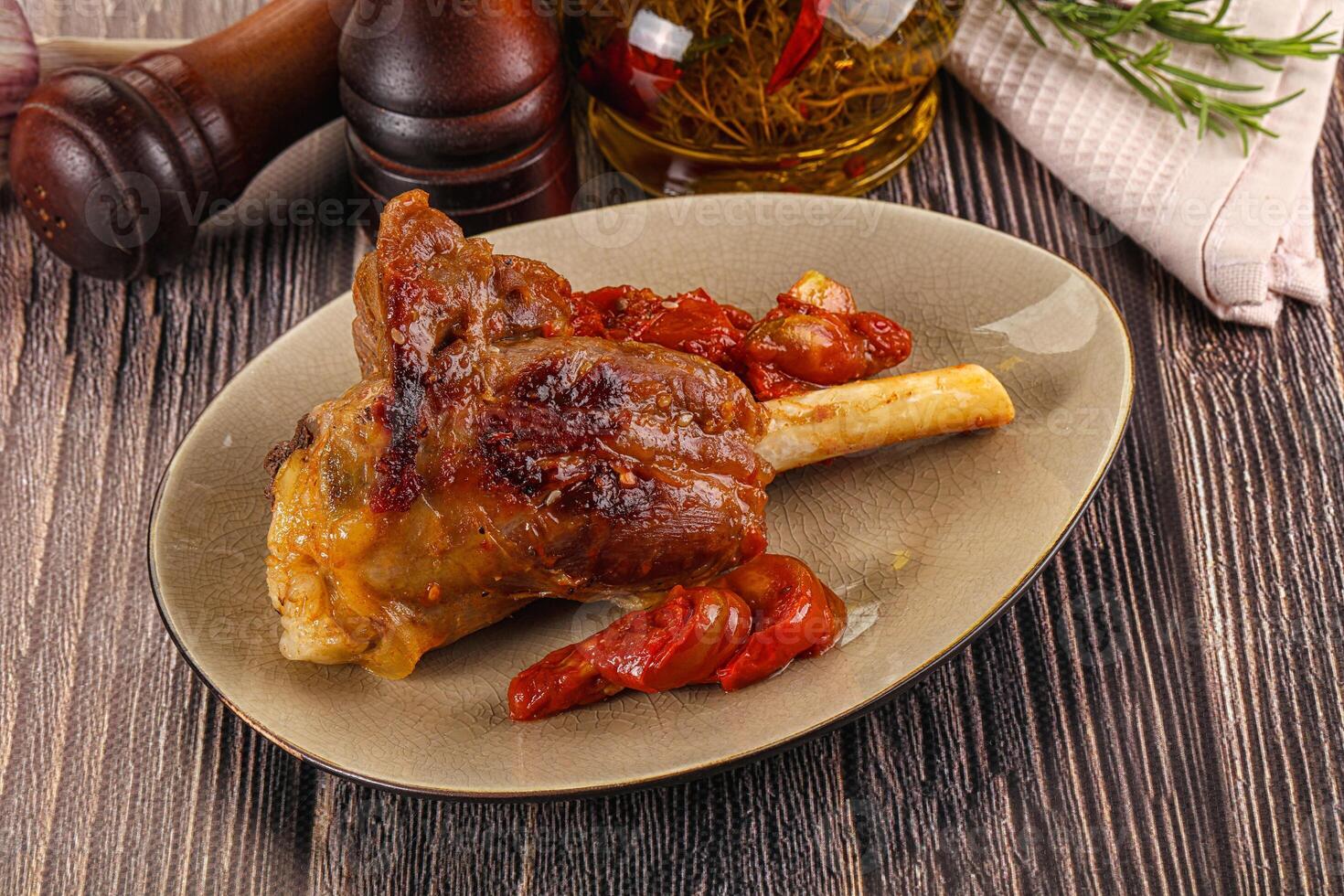 Baked lamb shank with vegetables photo