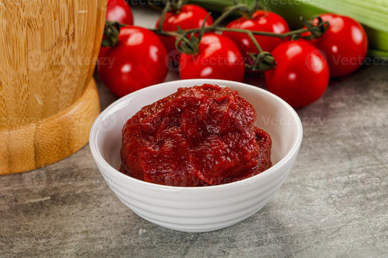 Red tomato paste in the bowl photo
