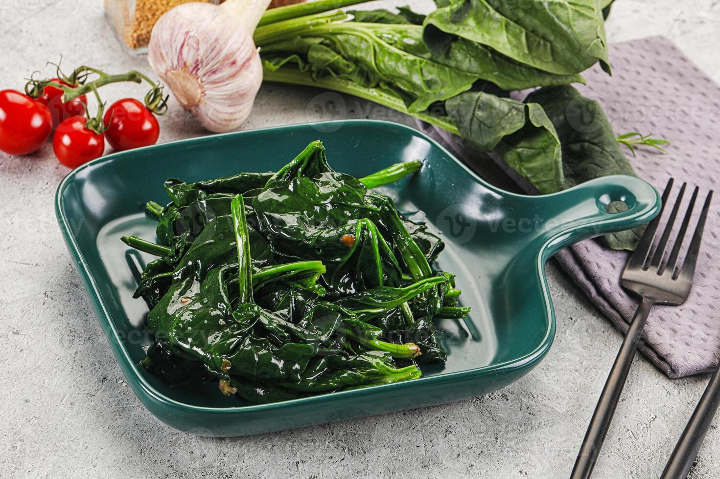 Coocked green spinach with oil photo