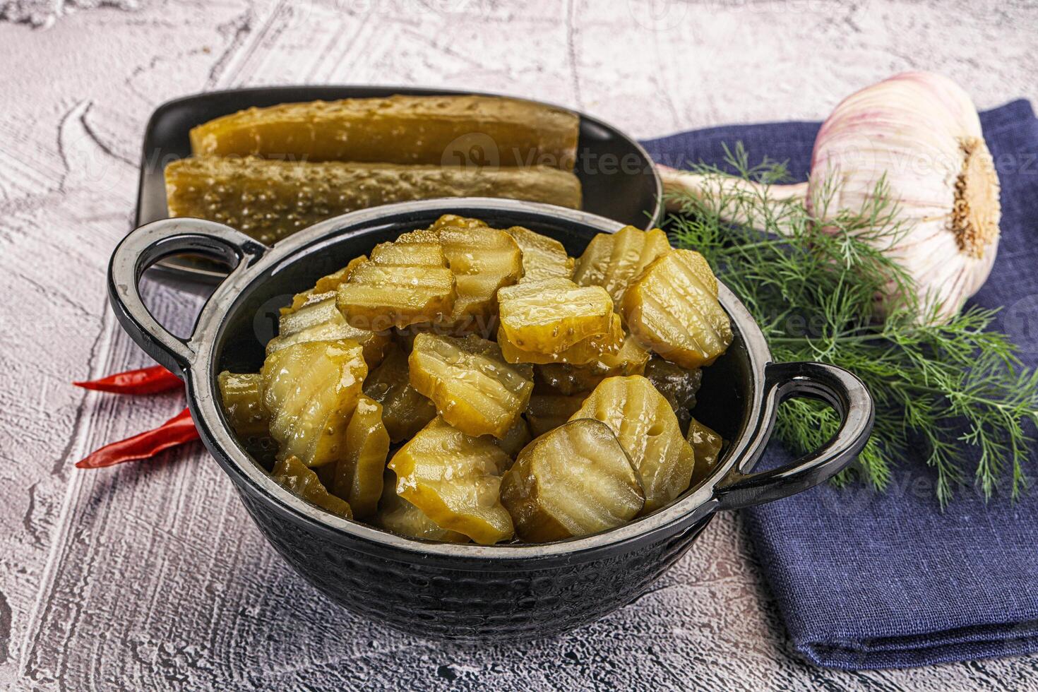 Sliced marinated cucumbers in the bowl photo