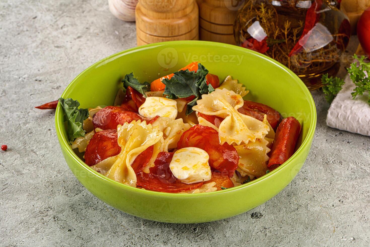 Italian pasta farfalle with pepperoni photo