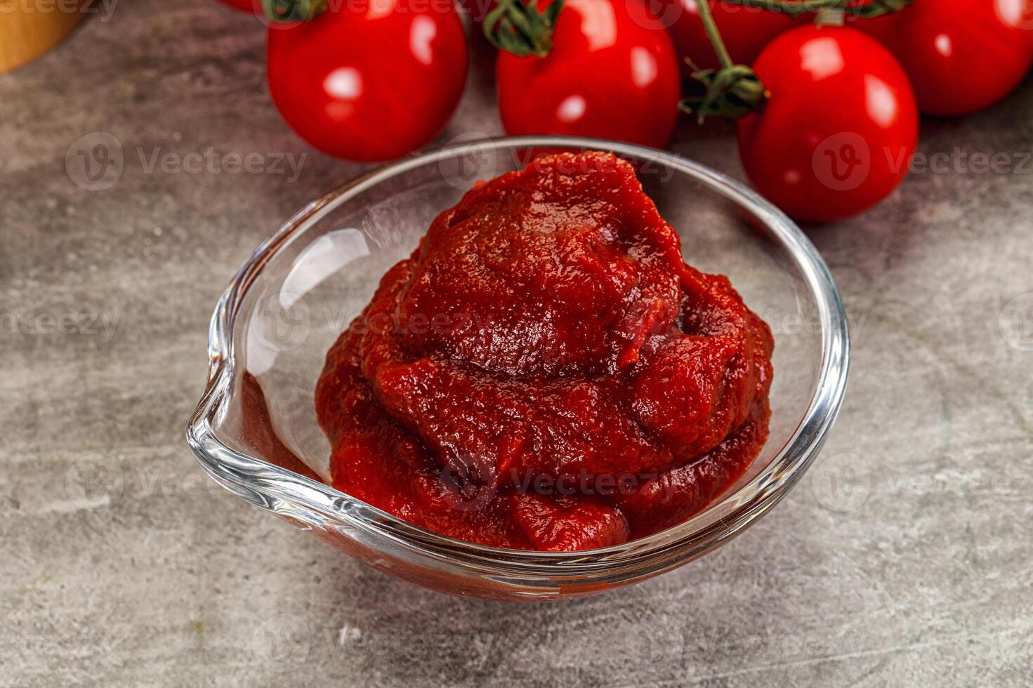 Red tomato paste in the bowl photo