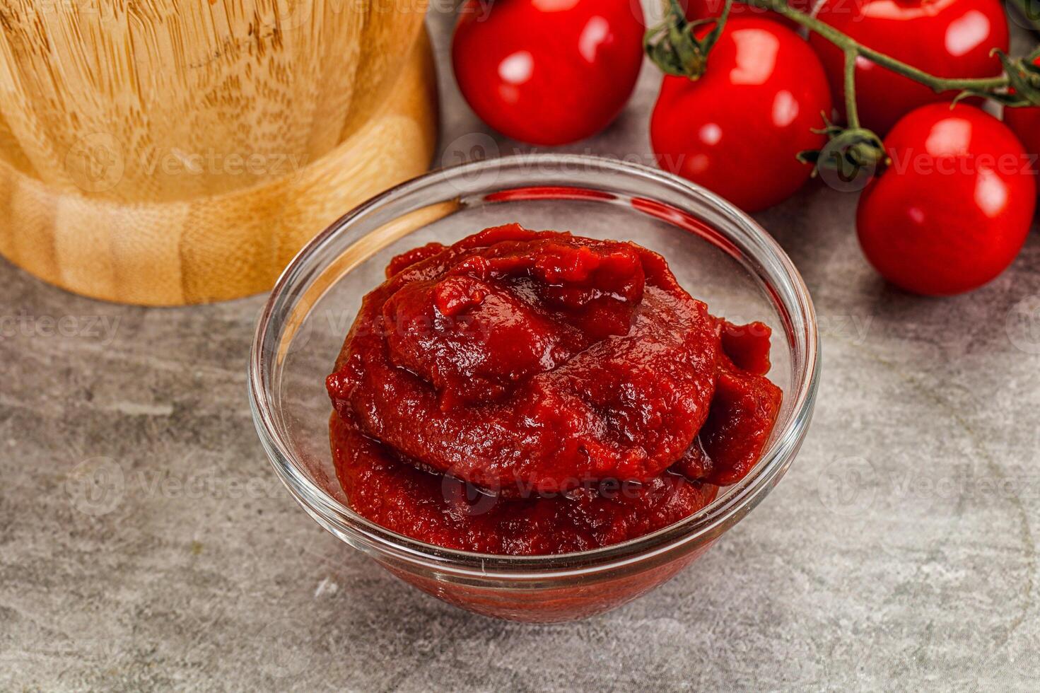 Red tomato paste in the bowl photo