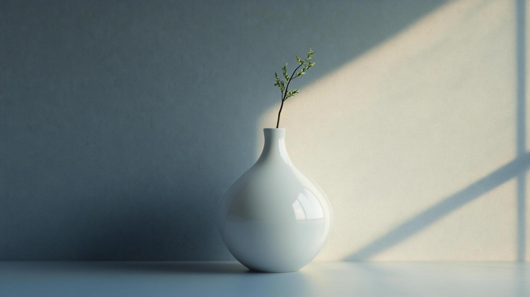A white vase with a green leaf in it sits on a table photo