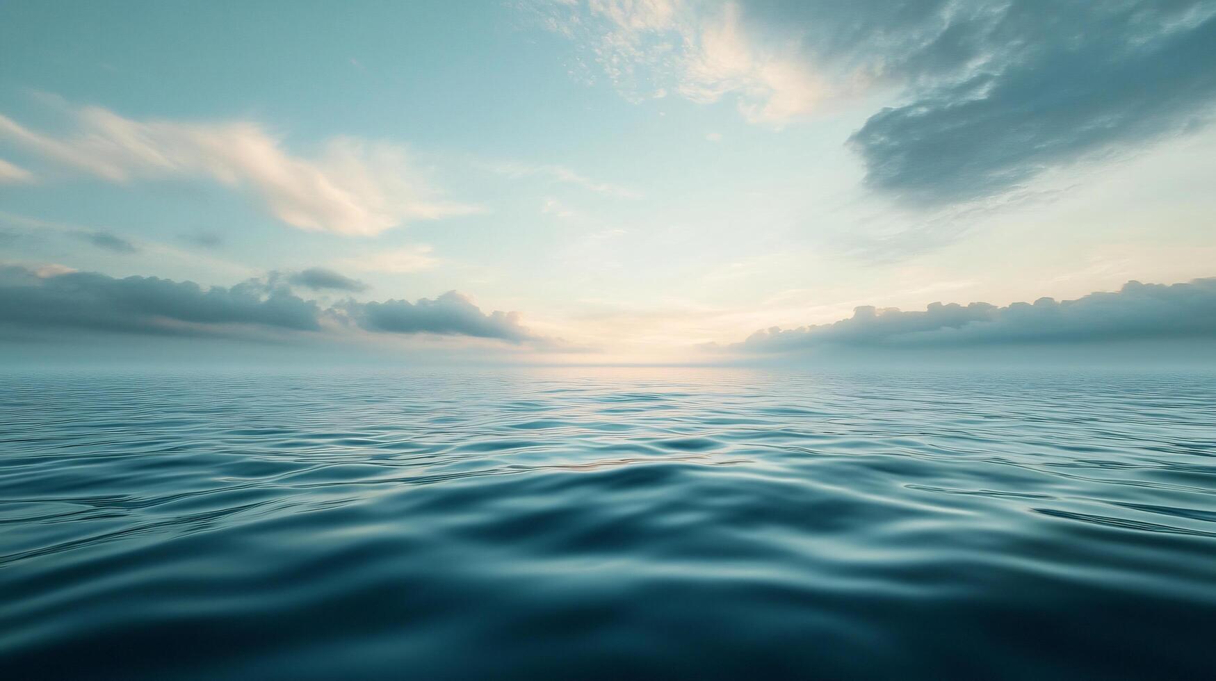 The ocean is calm and peaceful, with a beautiful blue sky in the background photo